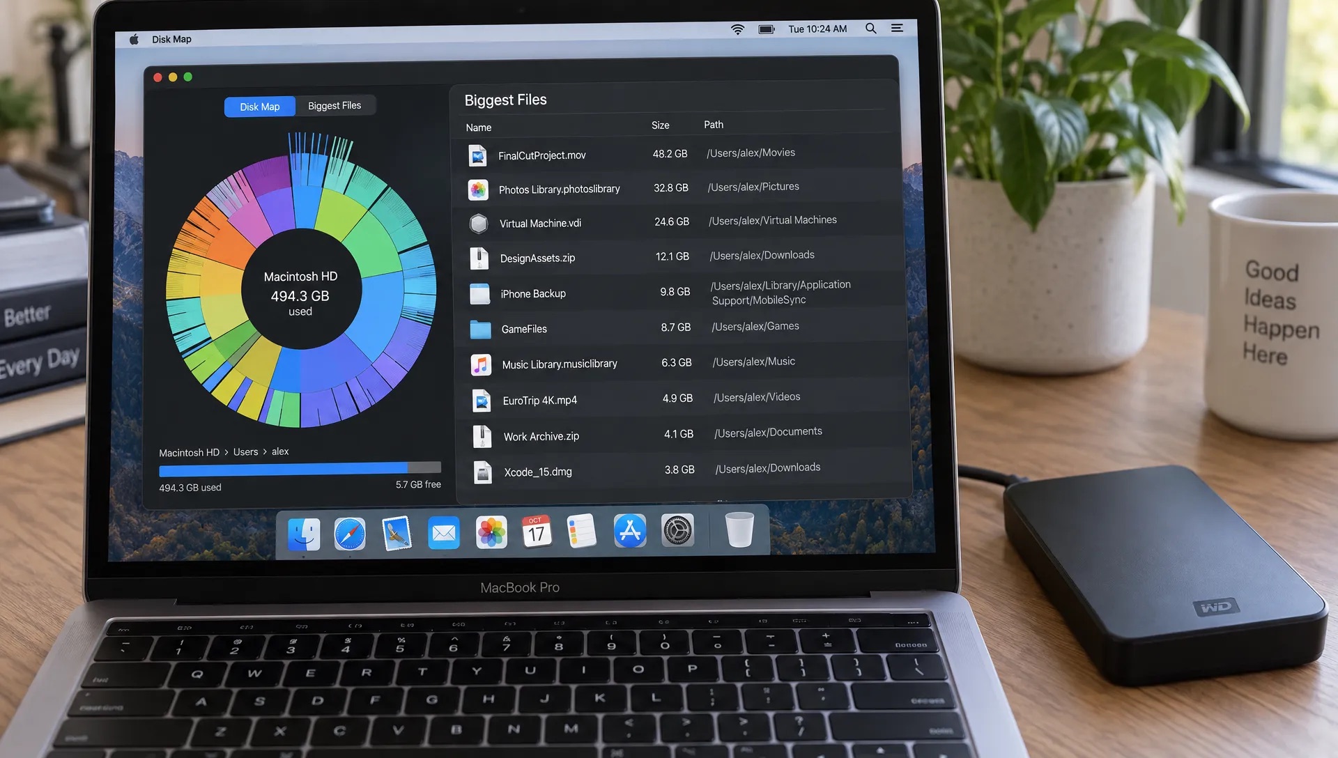 A MacBook displays a visual disk map beside a list of large files with paths and sizes, while a portable backup drive rests beside it.
